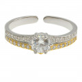 Silver solitaire ring with gold and platinum plating and white sapphires