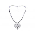 Necklace with a thick black cord and a metal perforated heart with white sapphires from the collection "BE MINE" by Marilou