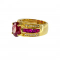 18K Gold Ring adorned with a Oval Ruby, a tow of square cut Rubies and two rows of Diamonds