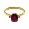 18K Gold Three-stone Ring adorned with a Ruby and two Diamonds