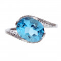 14K White Gold Ring adorned with a Blue Topaz and White Sapphires